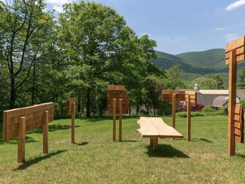 Color photograph of an outdoor wooden sculptural installation by Christina Tenaglia at the Al Held Foundation, 2021. Exhibition curated by Alyson Baker and River Valley Arts Collective